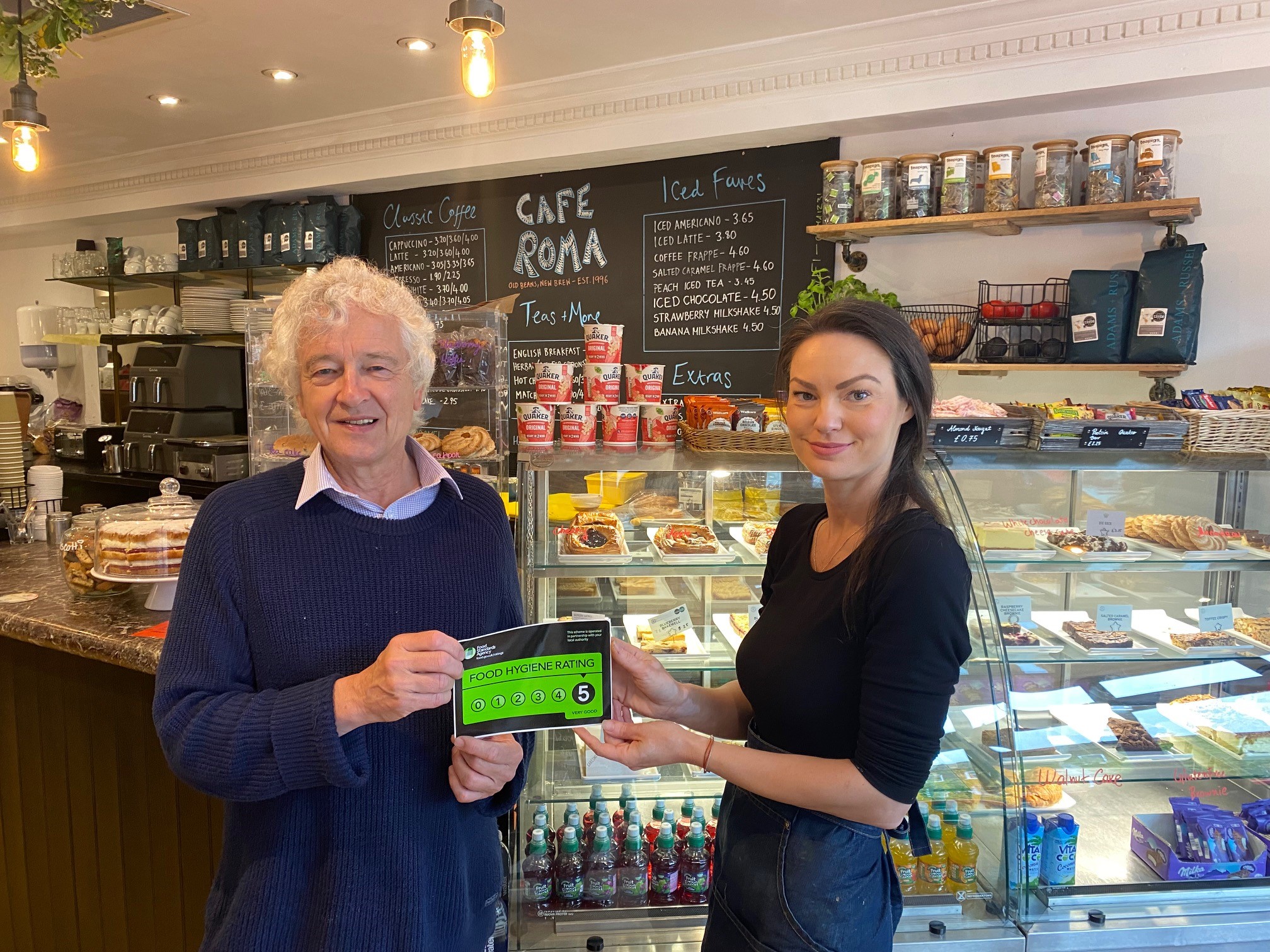 Councillor Anthony Rowlands presents a five-star food hygiene certificate to Cafe Roma owner Velina Grudeva