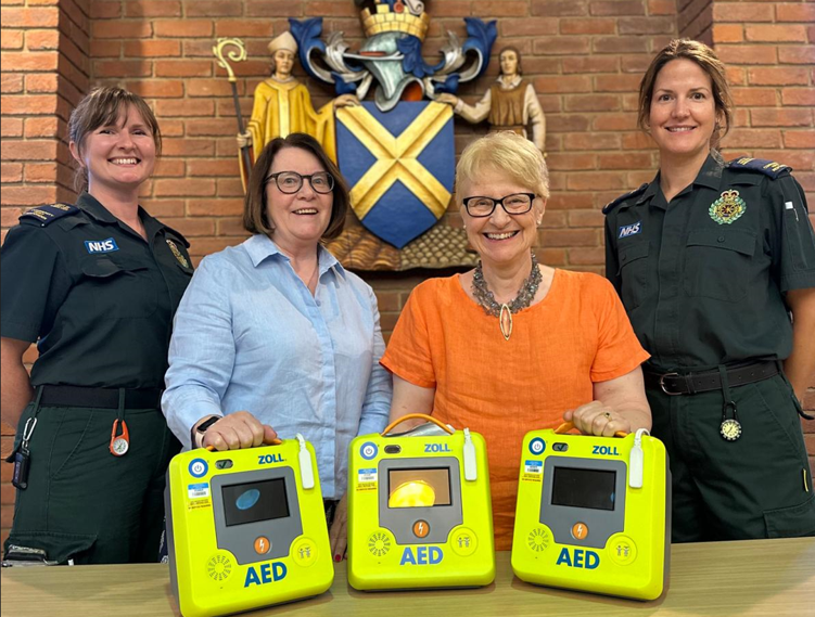 : left to right, Monica Cherry, Cllr Griffiths, Cllr Heritage and Vivienne Ford with the three defibrillators.