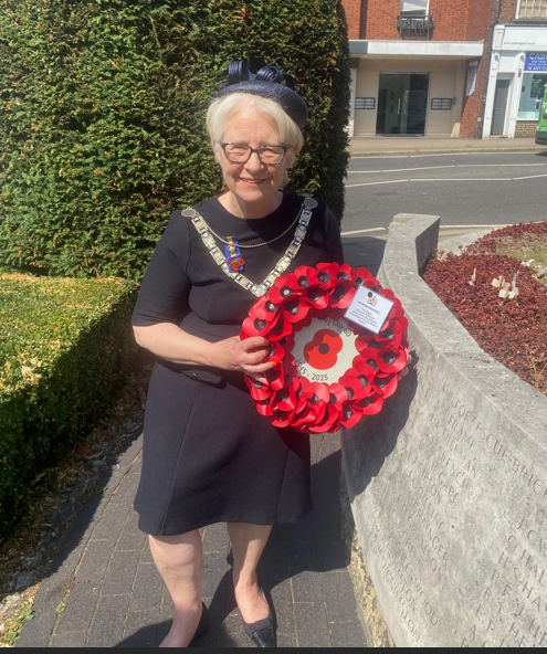 A person holding a wreath

AI-generated content may be incorrect.